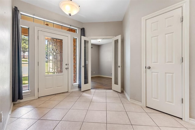 10650 Hunters Pointe, Edmond, OK 73034 - foyer entrance featuring light tile patterned floors, french doors, and baseboards