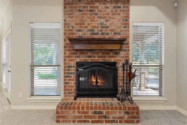 10650 Hunters Pointe, Edmond, OK 73034 - detailed view of carpet flooring, baseboards, and a brick fireplace