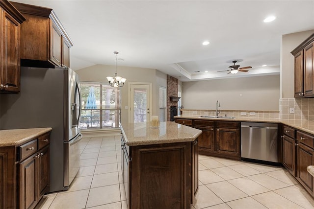 10650 Hunters Pointe, Edmond, OK 73034 - kitchen featuring appliances with stainless steel finishes, a sink, a ceiling fan, a center island, and light tile patterned flooring
