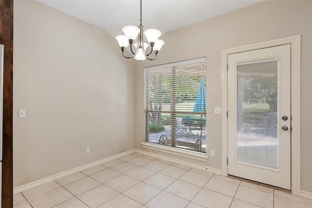 10650 Hunters Pointe, Edmond, OK 73034 - unfurnished dining area with light tile patterned floors, a chandelier, and baseboards
