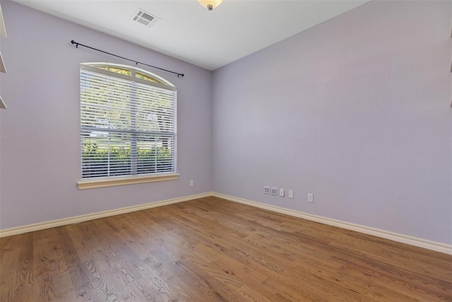 10650 Hunters Pointe, Edmond, OK 73034 - unfurnished room with healthy amount of natural light, wood finished floors, and baseboards