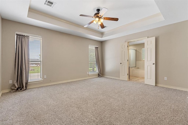 10650 Hunters Pointe, Edmond, OK 73034 - unfurnished room featuring a tray ceiling, a ceiling fan, light colored carpet, baseboards, and crown molding