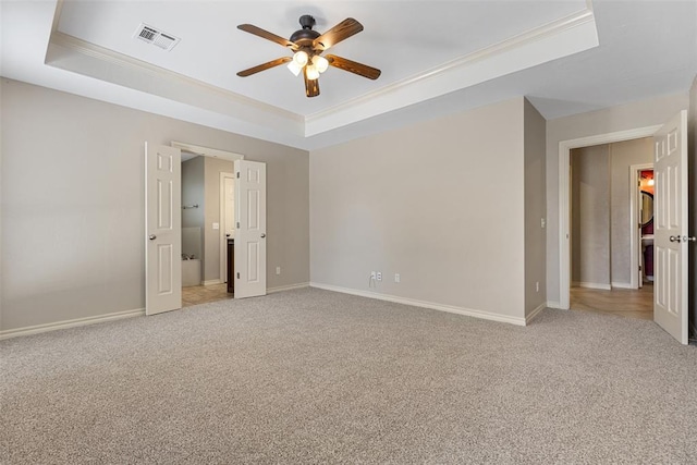 10650 Hunters Pointe, Edmond, OK 73034 - unfurnished bedroom with a raised ceiling, light carpet, crown molding, and baseboards