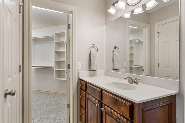 10650 Hunters Pointe, Edmond, OK 73034 - bathroom featuring vanity and a walk in closet