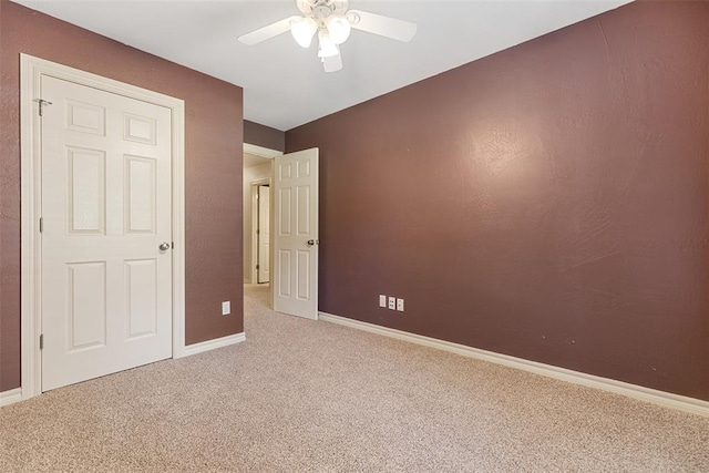 10650 Hunters Pointe, Edmond, OK 73034 - unfurnished bedroom featuring carpet, baseboards, and a ceiling fan