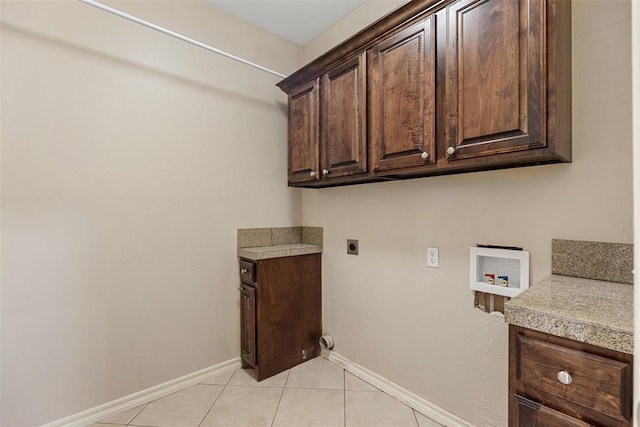 10650 Hunters Pointe, Edmond, OK 73034 - laundry area featuring cabinet space, washer hookup, electric dryer hookup, light tile patterned floors, and baseboards