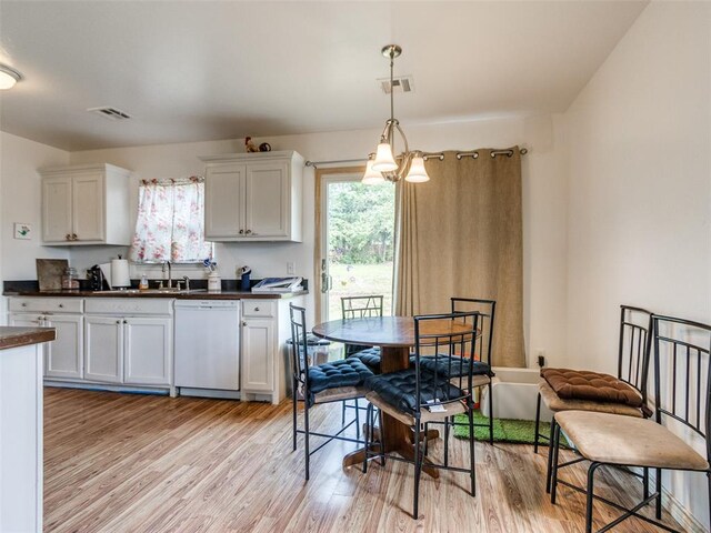 4900 S Post Rd, Oklahoma City, OK 73150 - kitchen with dishwasher, dark countertops, light wood finished floors, and white cabinets