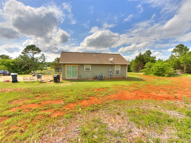 4900 S Post Rd, Oklahoma City, OK 73150 - back of house with a yard and central air condition unit