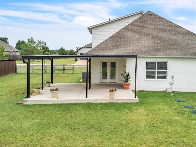 1330 Round Leaf Rd, Edmond, OK 73034 - back of property featuring roof with shingles, central air condition unit, a patio area, and brick siding
