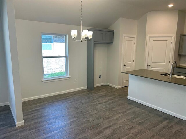 3008 NW 196th Pl, Edmond, OK 73012 - unfurnished dining area with a sink, vaulted ceiling, a chandelier, baseboards, and dark wood-type flooring