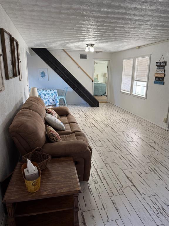 134 Wood St, Fort Cobb, OK 73038 - living area featuring wood finished floors and stairs