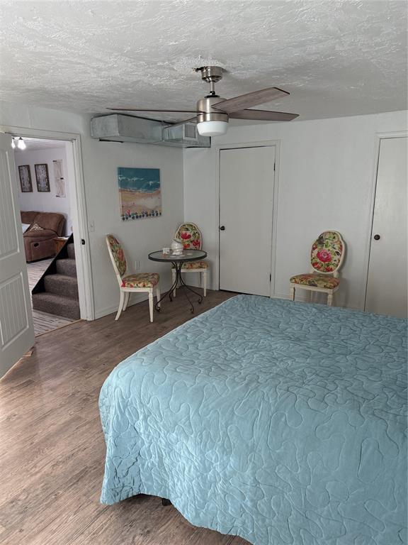 134 Wood St, Fort Cobb, OK 73038 - bedroom featuring a textured ceiling, wood finished floors, and ceiling fan