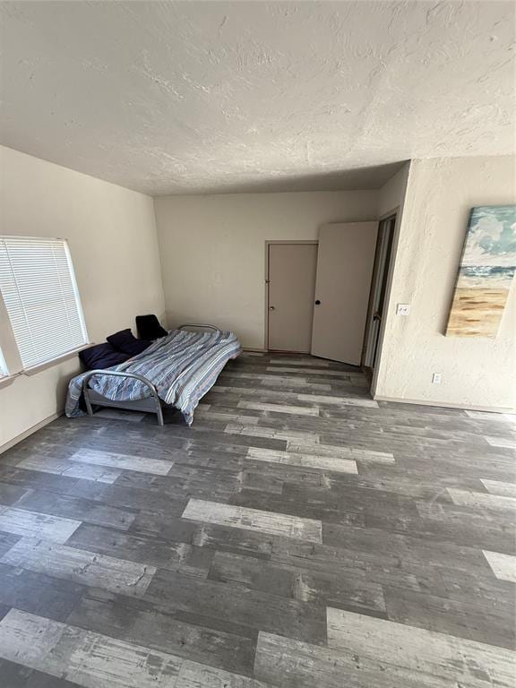 134 Wood St, Fort Cobb, OK 73038 - bedroom with a textured ceiling and wood finished floors