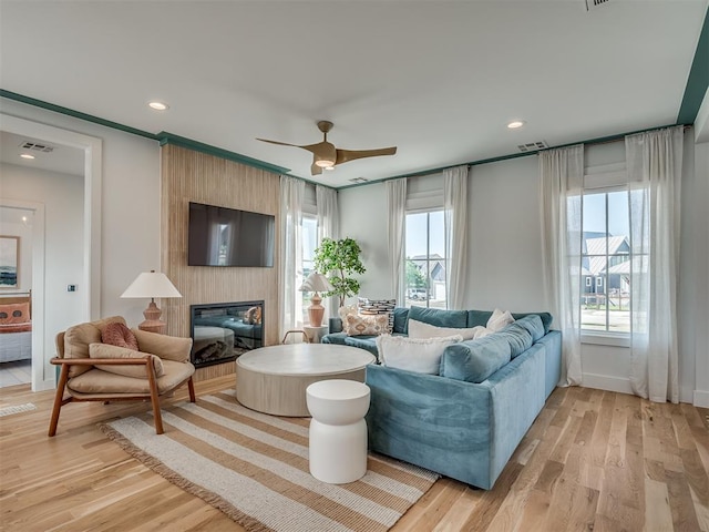 51 Lower Green Way, Carlton Landing, OK 74432 - living room with light wood-type flooring, a ceiling fan, a fireplace, baseboards, and recessed lighting