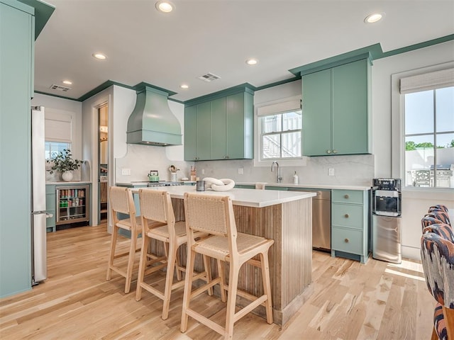 51 Lower Green Way, Carlton Landing, OK 74432 - kitchen with custom exhaust hood, green cabinetry, freestanding refrigerator, decorative backsplash, and recessed lighting