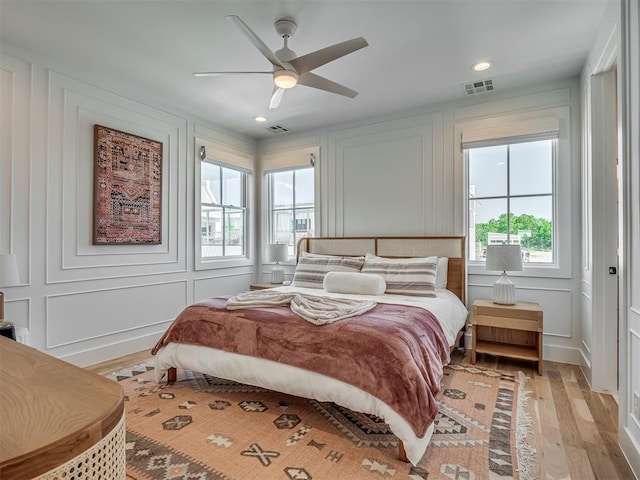 51 Lower Green Way, Carlton Landing, OK 74432 - bedroom featuring a decorative wall, light wood finished floors, a ceiling fan, and recessed lighting