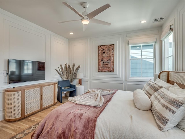 51 Lower Green Way, Carlton Landing, OK 74432 - bedroom featuring a decorative wall, light wood-style floors, ceiling fan, and recessed lighting