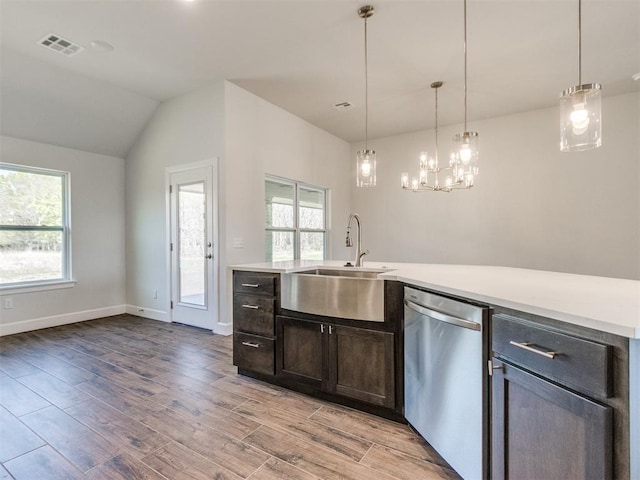 1241 SW 139th St, Oklahoma City, OK 73170 - kitchen with stainless steel dishwasher, a sink, light wood-type flooring, light countertops, and lofted ceiling