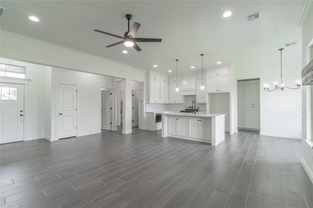 9217 SW 43rd St, Oklahoma City, OK 73179 - unfurnished living room with a sink, a ceiling fan, baseboards, recessed lighting, and crown molding