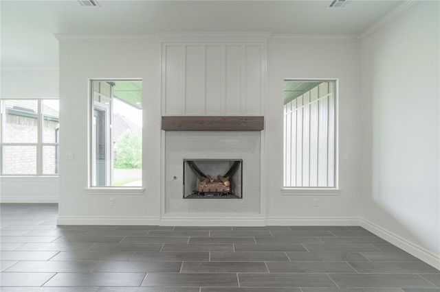 9217 SW 43rd St, Oklahoma City, OK 73179 - unfurnished living room featuring a large fireplace, wood tiled floors, baseboards, and crown molding