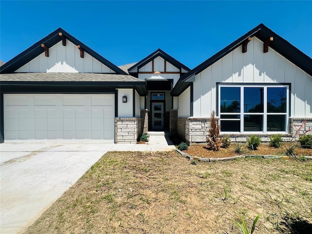 913 SW 141st St, Oklahoma City, OK 73170 - view of front of property featuring board and batten siding, a garage, roof with shingles, and stone siding