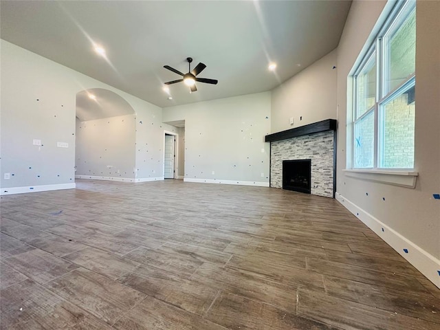 913 SW 141st St, Oklahoma City, OK 73170 - unfurnished living room featuring ceiling fan, wood finished floors, a fireplace, and baseboards