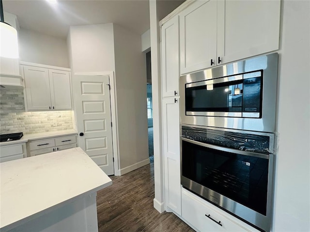 1209 SW 141st St, Oklahoma City, OK 73170 - kitchen with stainless steel appliances, tasteful backsplash, white cabinets, and dark wood-style floors