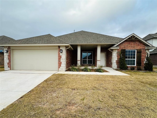 1233 SW 139th St, Oklahoma City, OK 73170 - view of front facade with a garage, a shingled roof, a front yard, brick siding, and driveway
