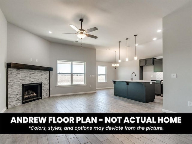 8600 NW 75th St, Oklahoma City, OK 73132 - kitchen with a ceiling fan, open floor plan, a fireplace, light wood-type flooring, and a chandelier