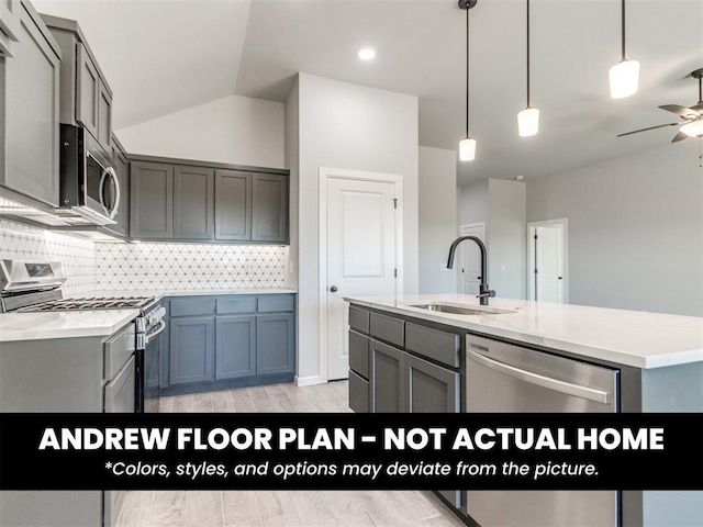 8600 NW 75th St, Oklahoma City, OK 73132 - kitchen with stainless steel appliances, a sink, gray cabinetry, a ceiling fan, and backsplash