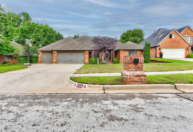 608 Shadow View Ct, Norman, OK 73072 - view of front facade with driveway, brick siding, an attached garage, and a front lawn