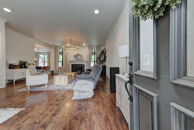 608 Shadow View Ct, Norman, OK 73072 - living room featuring crown molding, a premium fireplace, a chandelier, dark wood-type flooring, and recessed lighting