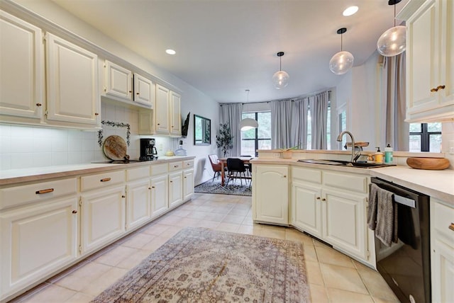 608 Shadow View Ct, Norman, OK 73072 - kitchen with dishwasher, a sink, light tile patterned flooring, tasteful backsplash, and light countertops