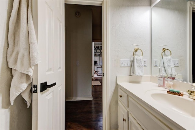 608 Shadow View Ct, Norman, OK 73072 - bathroom featuring vanity, wood finished floors, baseboards, and a textured wall