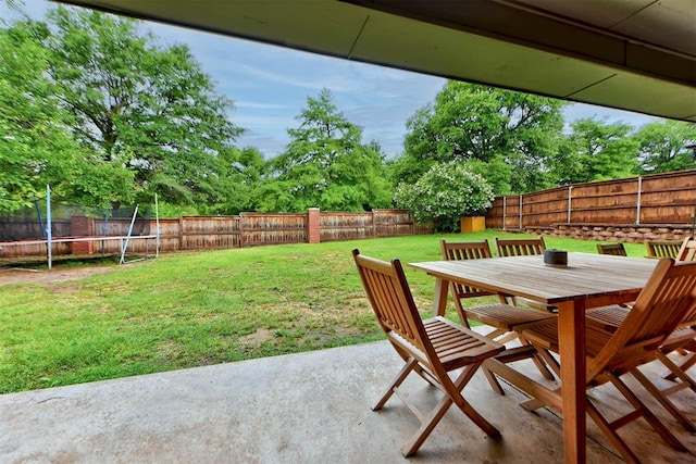 608 Shadow View Ct, Norman, OK 73072 - view of yard featuring a trampoline, a patio, outdoor dining area, and view of scattered trees