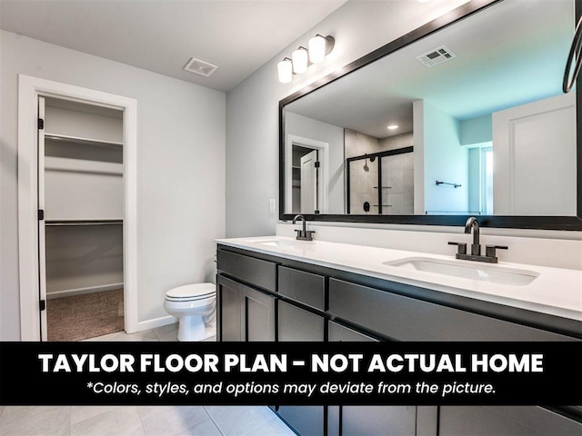 8509 NW 76th St, Oklahoma City, OK 73132 - bathroom with double vanity, a shower stall, toilet, a walk in closet, and baseboards