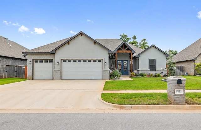 4813 Hambletonian Ln, Mustang, OK 73064 - view of front of property with an attached garage, driveway, stucco siding, a front lawn, and brick siding