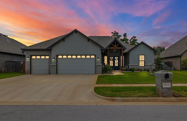 4813 Hambletonian Ln, Mustang, OK 73064 - view of front facade featuring a garage, french doors, concrete driveway, a front yard, and stucco siding