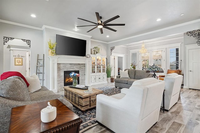 4813 Hambletonian Ln, Mustang, OK 73064 - living room featuring a ceiling fan, ornamental molding, a stone fireplace, and recessed lighting