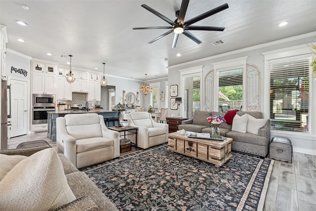 4813 Hambletonian Ln, Mustang, OK 73064 - living room featuring recessed lighting, ceiling fan, a chandelier, crown molding, and baseboards