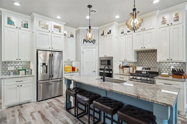 4813 Hambletonian Ln, Mustang, OK 73064 - kitchen with appliances with stainless steel finishes, a sink, white cabinetry, decorative backsplash, and recessed lighting