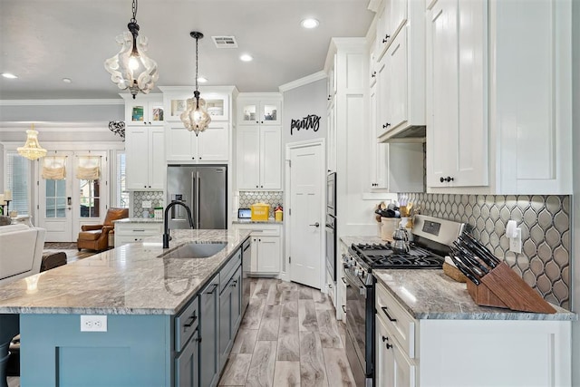 4813 Hambletonian Ln, Mustang, OK 73064 - kitchen with appliances with stainless steel finishes, a sink, crown molding, white cabinets, and glass insert cabinets