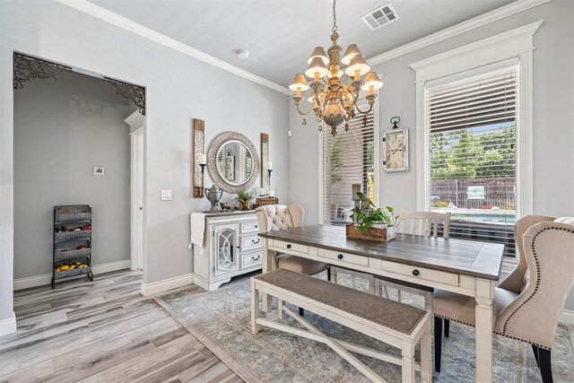 4813 Hambletonian Ln, Mustang, OK 73064 - dining area featuring a chandelier, crown molding, baseboards, and light wood-type flooring