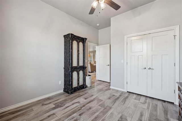 4813 Hambletonian Ln, Mustang, OK 73064 - unfurnished bedroom with light wood-style flooring, baseboards, ceiling fan, and a closet