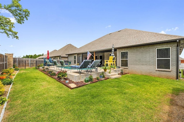 4813 Hambletonian Ln, Mustang, OK 73064 - back of property with brick siding, a patio area, and roof with shingles