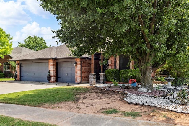 704 N Geronimo Way, Mustang, OK 73064 - view of front of home with brick siding, a garage, concrete driveway, and a shingled roof