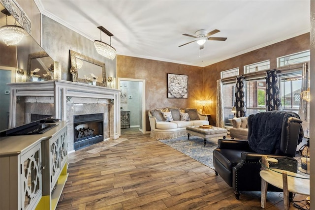 704 N Geronimo Way, Mustang, OK 73064 - living area with a tiled fireplace, ceiling fan, hardwood / wood-style floors, and ornamental molding