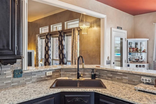 704 N Geronimo Way, Mustang, OK 73064 - kitchen featuring light stone countertops and a chandelier
