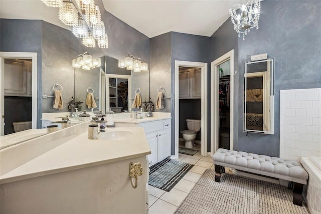 704 N Geronimo Way, Mustang, OK 73064 - bathroom featuring a chandelier, tile patterned floors, vanity, and a walk in closet