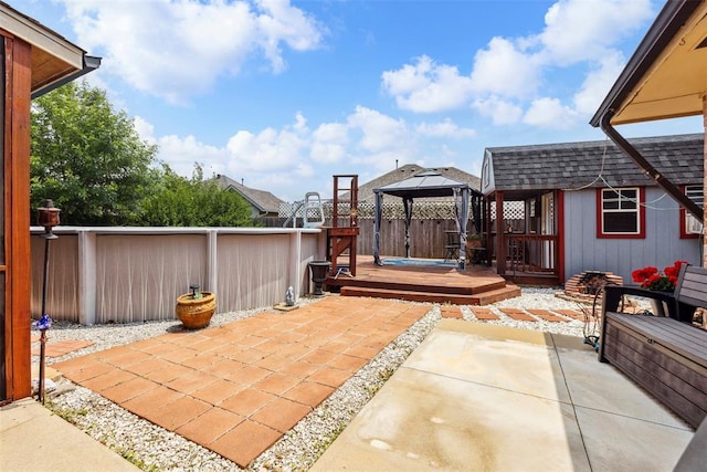 704 N Geronimo Way, Mustang, OK 73064 - fenced backyard featuring a gazebo, a patio area, and a deck